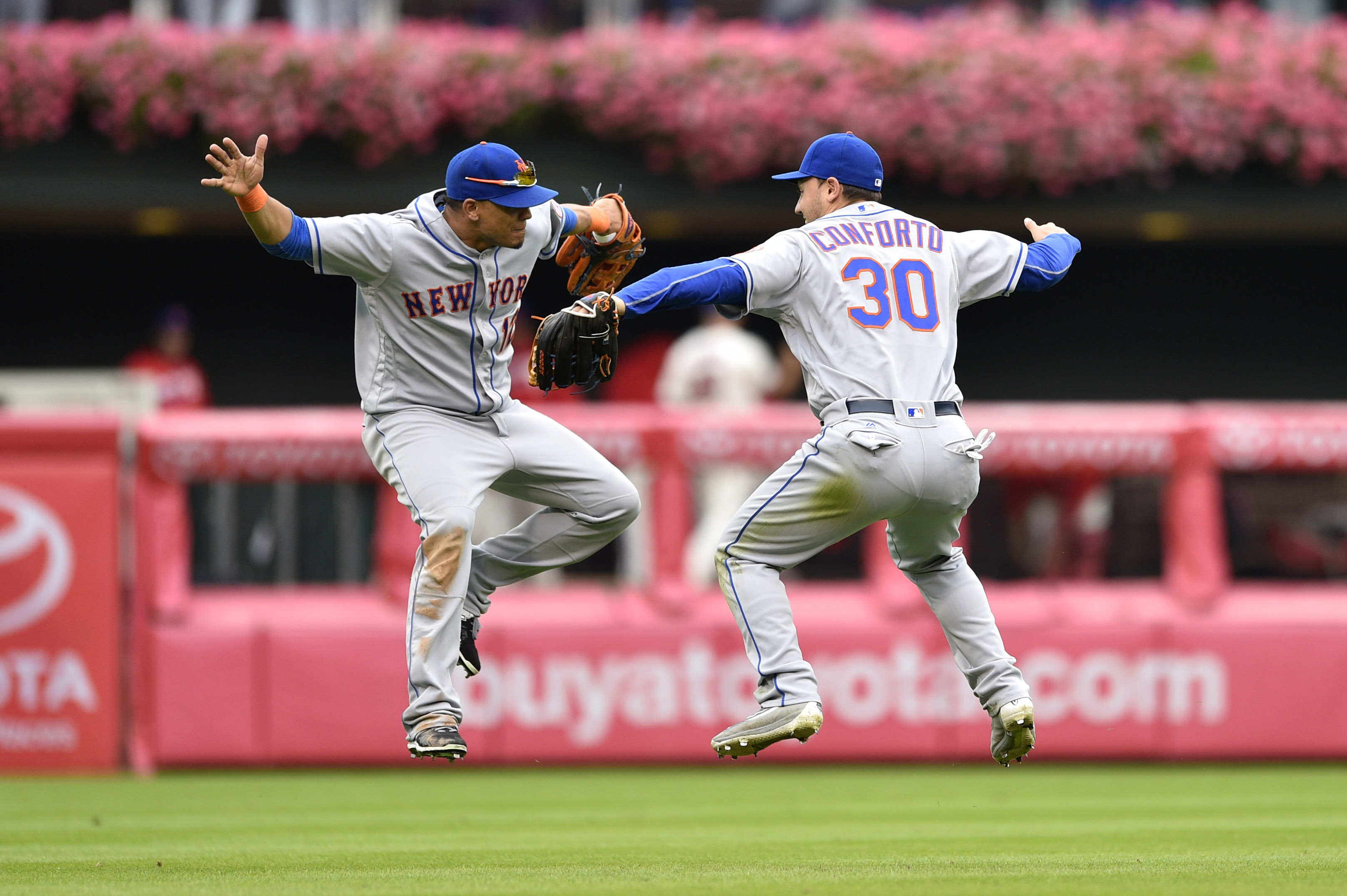 New York Mets' Jose Reyes, left, catches Philadelphia Phillies